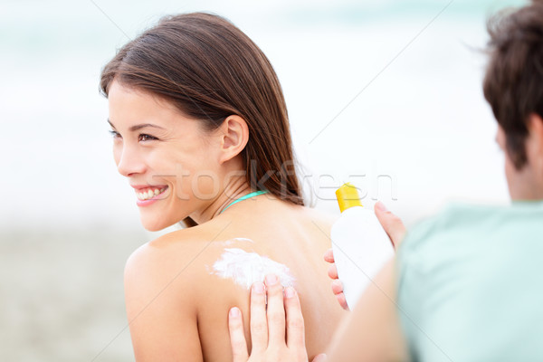 Suntan lotion /  Sunscreen - young couple on beach Stock photo © Maridav