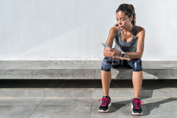 Fitness runner girl using music mobile phone app Stock photo © Maridav