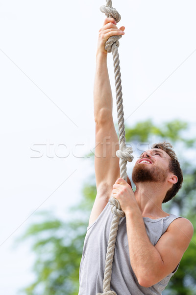Fit strong man cross training climbing rope Stock photo © Maridav