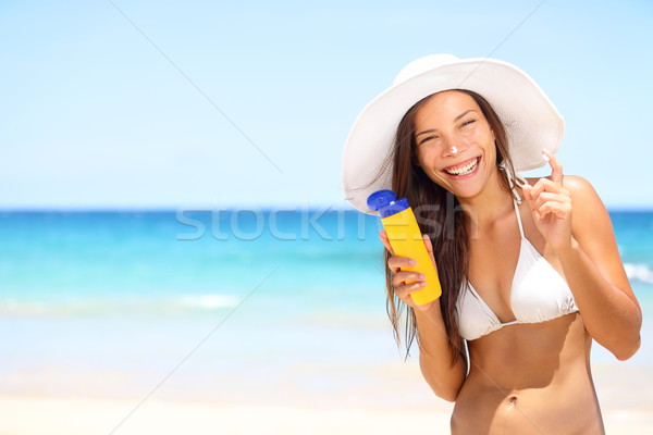 Sunscreen beach woman in bikini applying sun block Stock photo © Maridav