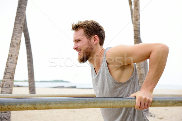 Stock photo: Cross fit man working out doing dips exercises