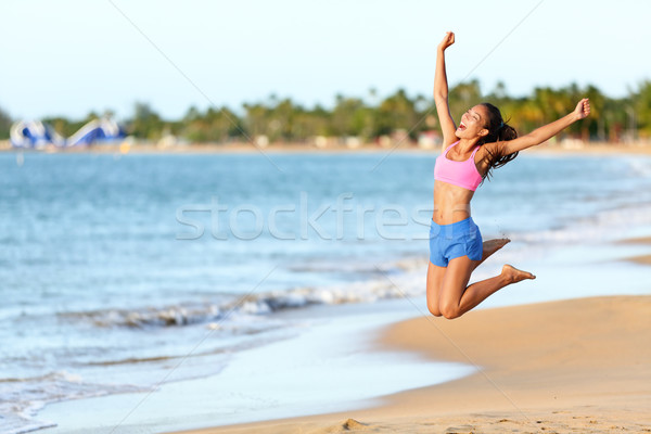 Excited Woman Jumping At Beach - Fitness girl Stock photo © Maridav