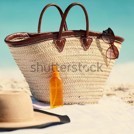 Sunscreen beach woman putting sunblock oil on legs Stock photo © Maridav