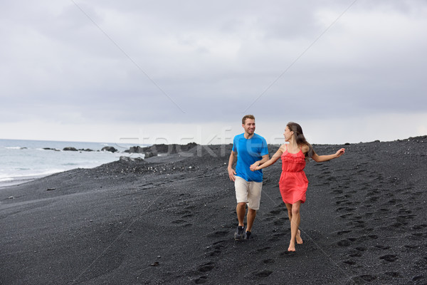 Couple walking travel holidays black sand beach Stock photo © Maridav