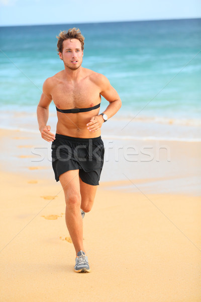 Runner man running with heart rate monitor Stock photo © Maridav