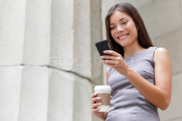 Stock photo: Young smart professional woman using smartphone