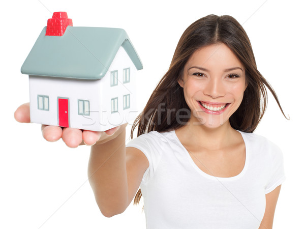 Home / house concept - woman holding mini house Stock photo © Maridav