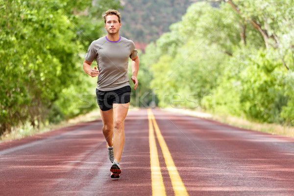 Sport and fitness runner man running on road Stock photo © Maridav