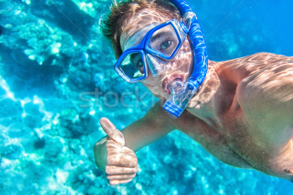 Snorkeling man underwater giving thumbs up Stock photo © Maridav