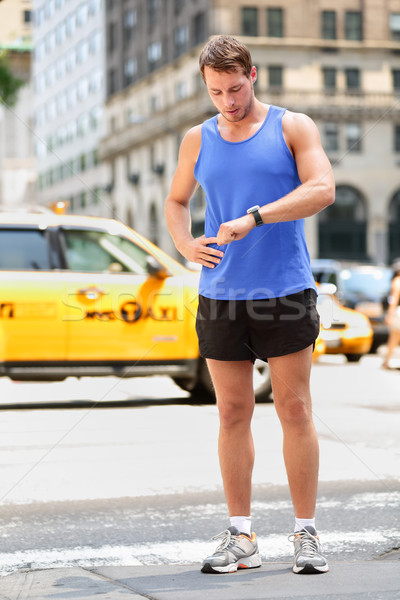 Stock photo: Runner looking at smart watch in New York City