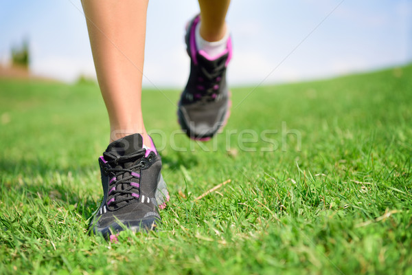 Stock photo: Runner athlete feet running on grass fitness woman