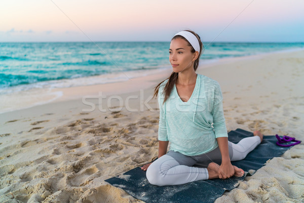 Yoga woman stretching leg with pigeon pose stretch Stock photo © Maridav