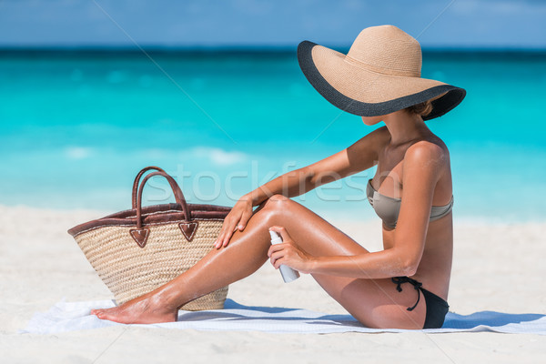 Sunscreen spray bottle woman applying body lotion Stock photo © Maridav