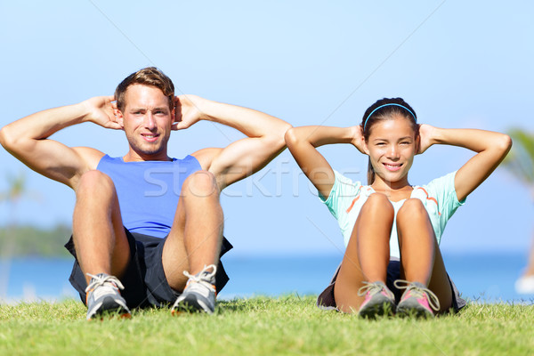 Sit ups - fitness couple exercising sit up outside Stock photo © Maridav