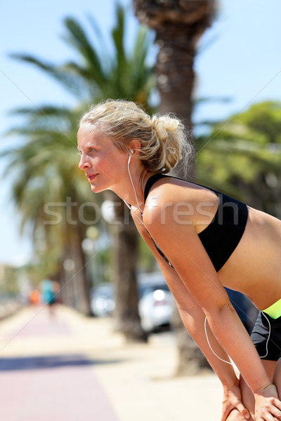 Fit runner woman taking a break while jogging Stock photo © Maridav