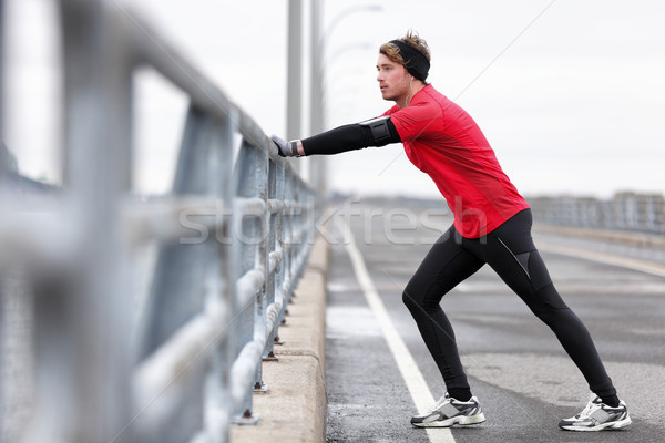 Stock photo: Man athlete stretching legs in winter outdoor run
