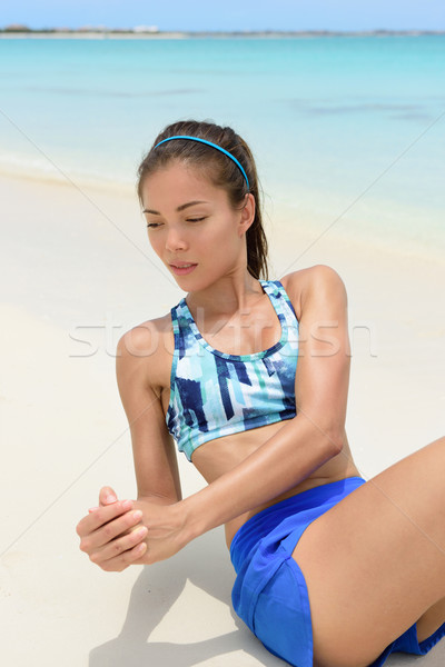 Stock photo: Fitness woman doing ab exercise workout on beach