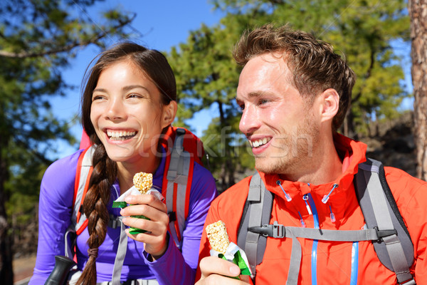 Stock photo: Couple eating muesli bar hiking happy