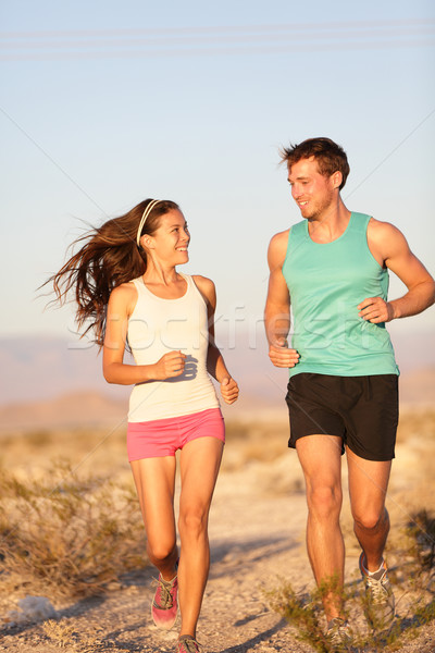 Runners - Active fitness couple running laughing Stock photo © Maridav