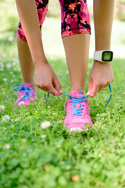 Weight loss - runner tying laces with smartwatch Stock photo © Maridav