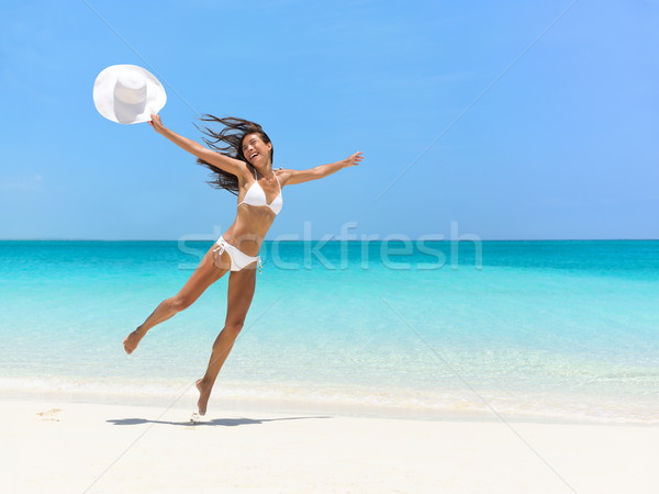 Carefree Woman Jumping At Beach During Summer Stock photo © Maridav