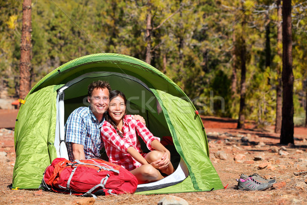 People camping in tent - happy backpacking couple Stock photo © Maridav
