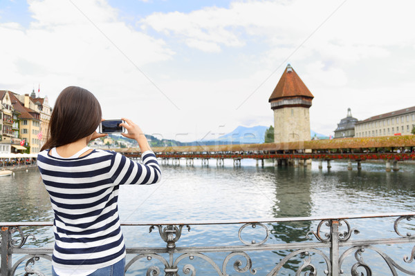 Tourist taking photograph in Lucerne Switzerland Stock photo © Maridav