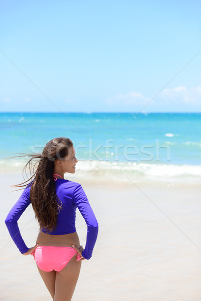Woman relaxing on beach in sun protection swimwear Stock photo © Maridav