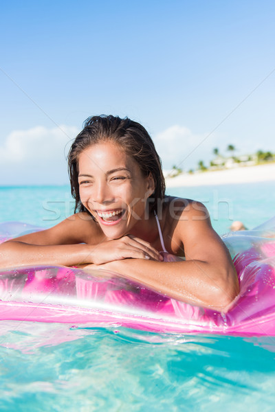 Happy beach woman ocean swimming on float bed Stock photo © Maridav