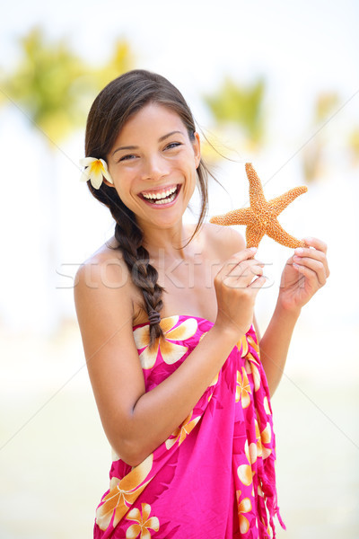 Summer vacation woman smiling happy with starfish Stock photo © Maridav