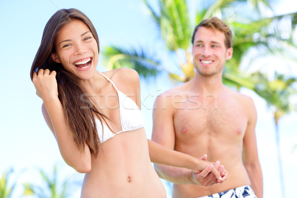 Couple amusement plage mains tenant bikini [[stock_photo]] © Maridav