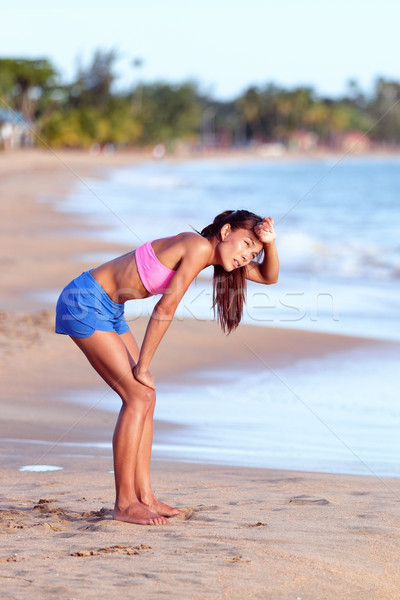 Tired Female Runner Bending On Beach After Running Stock photo © Maridav