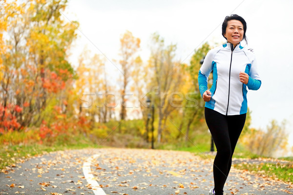 Mature Asian woman running active in her 50s Stock photo © Maridav