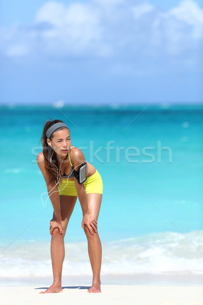 Running fitness woman exhausted after run on beach Stock photo © Maridav