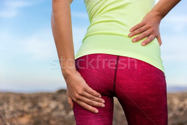 Lower back glute muscle cramp pain athlete runner Stock photo © Maridav