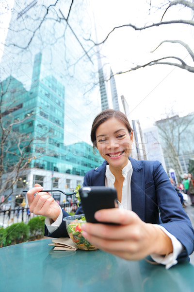 Young business woman on smartphone in lunch break Stock photo © Maridav