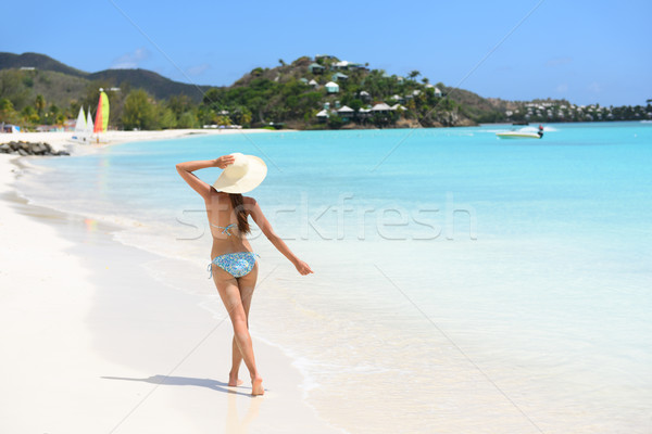 Beach travel woman bikini wearing sun hat walking Stock photo © Maridav