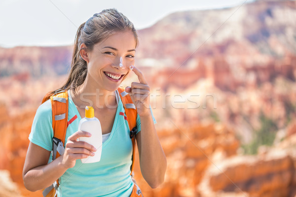 Hiker sunscreen - Woman hiking putting sunblock Stock photo © Maridav