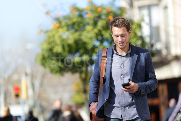 Business person man on mobile phone in city street Stock photo © Maridav