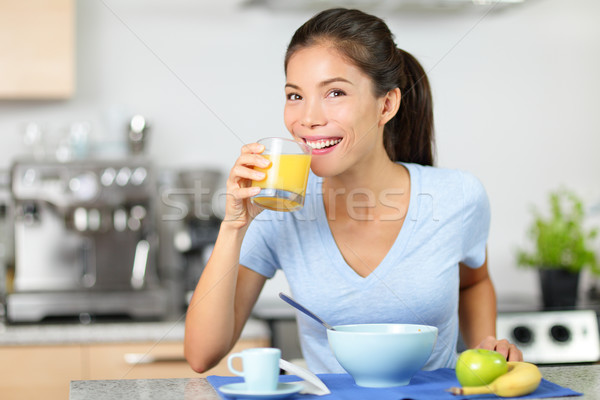 Woman drinking orange juice eating breakfast Stock photo © Maridav