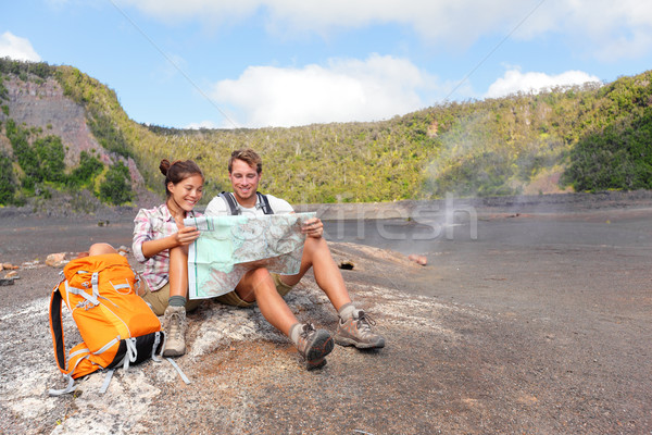 Couple hiking on volcano on Hawaii looking at map Stock photo © Maridav