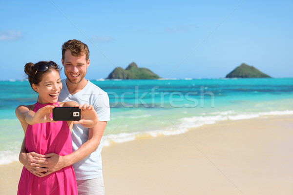 Beach vacation couple taking selfie on smartphone Stock photo © Maridav