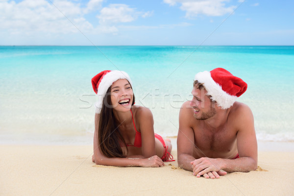 Christmas couple relaxing on beach winter vacation Stock photo © Maridav