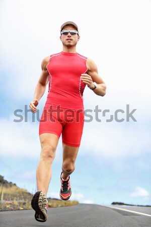 Triathlete running man Stock photo © Maridav