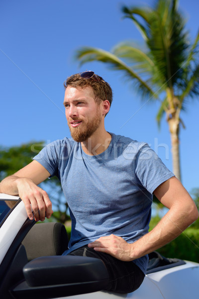 Handsome man showing off new luxury cabriolet car Stock photo © Maridav