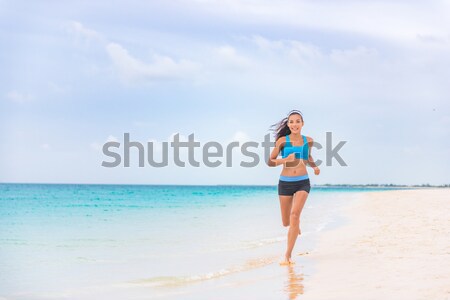 Healthy and active running woman jogging on beach Stock photo © Maridav