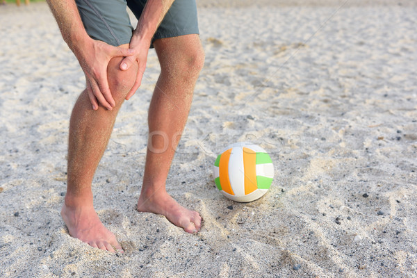 Sports knee injury on man playing beach volleyball Stock photo © Maridav