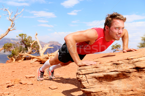 Fitness athlete training push ups in nature Stock photo © Maridav