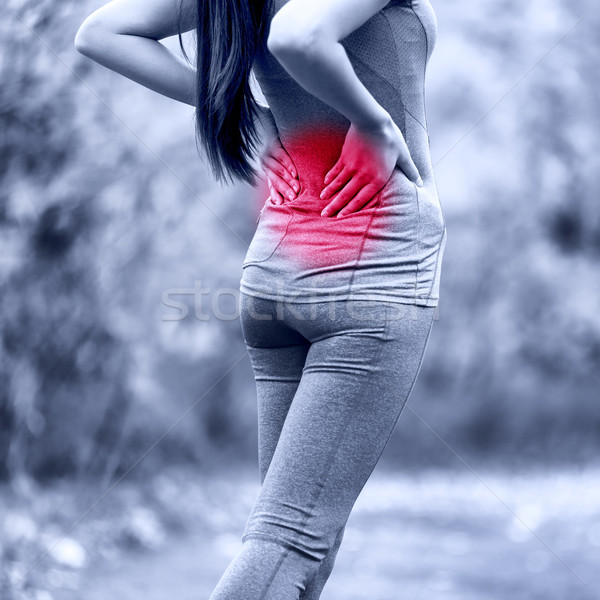 Sport woman with back problem - muscle pain injury Stock photo © Maridav