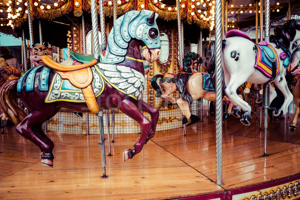 Stock photo: Old French carousel in a holiday park. Three horses and airplane on a traditional fairground vintage